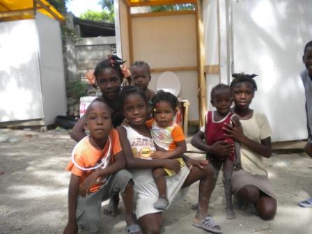 Kids posing with composting toilet (Household Toilet Project)